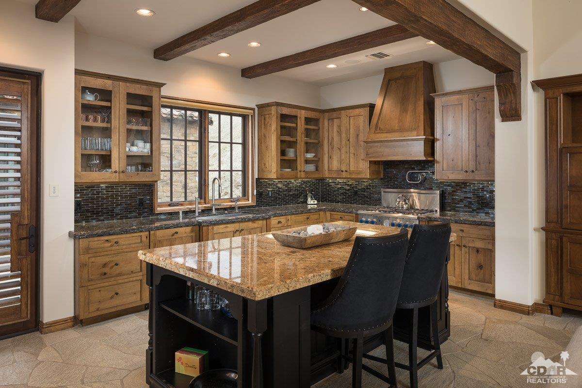 1 Santa Rosa Mountain Lane Rancho Mirage, CA 92270 - Photo 6 of 23 a kitchen with granite countertop a sink and wooden cabinets