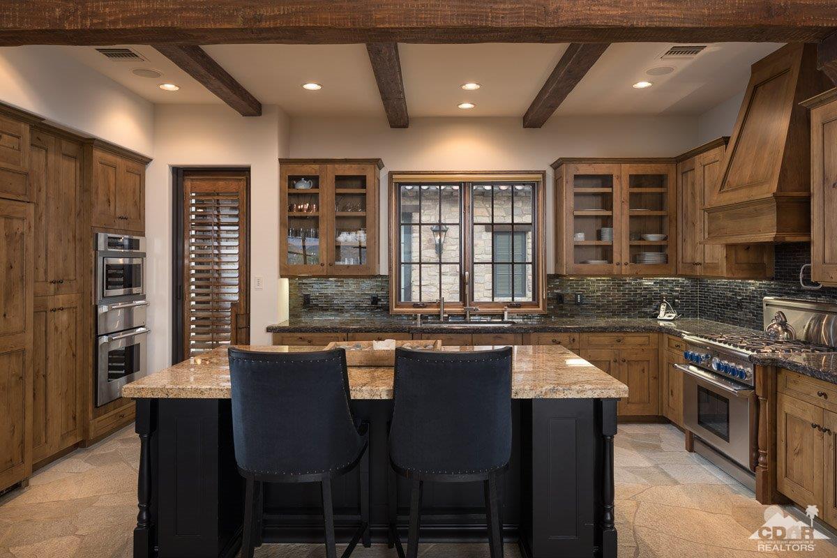 1 Santa Rosa Mountain Lane Rancho Mirage, CA 92270 - Photo 7 of 23 a kitchen with stainless steel appliances granite countertop a stove and cabinets