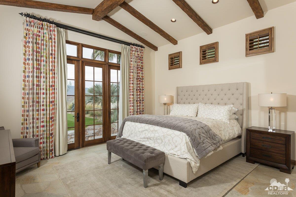 1 Santa Rosa Mountain Lane Rancho Mirage, CA 92270 - Photo 8 of 23 a spacious bedroom with a bed and a couch