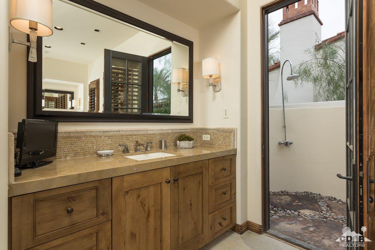 1 Santa Rosa Mountain Lane Rancho Mirage, CA 92270 - Photo 10 of 23 a bathroom with a double vanity sink mirror and next to a window