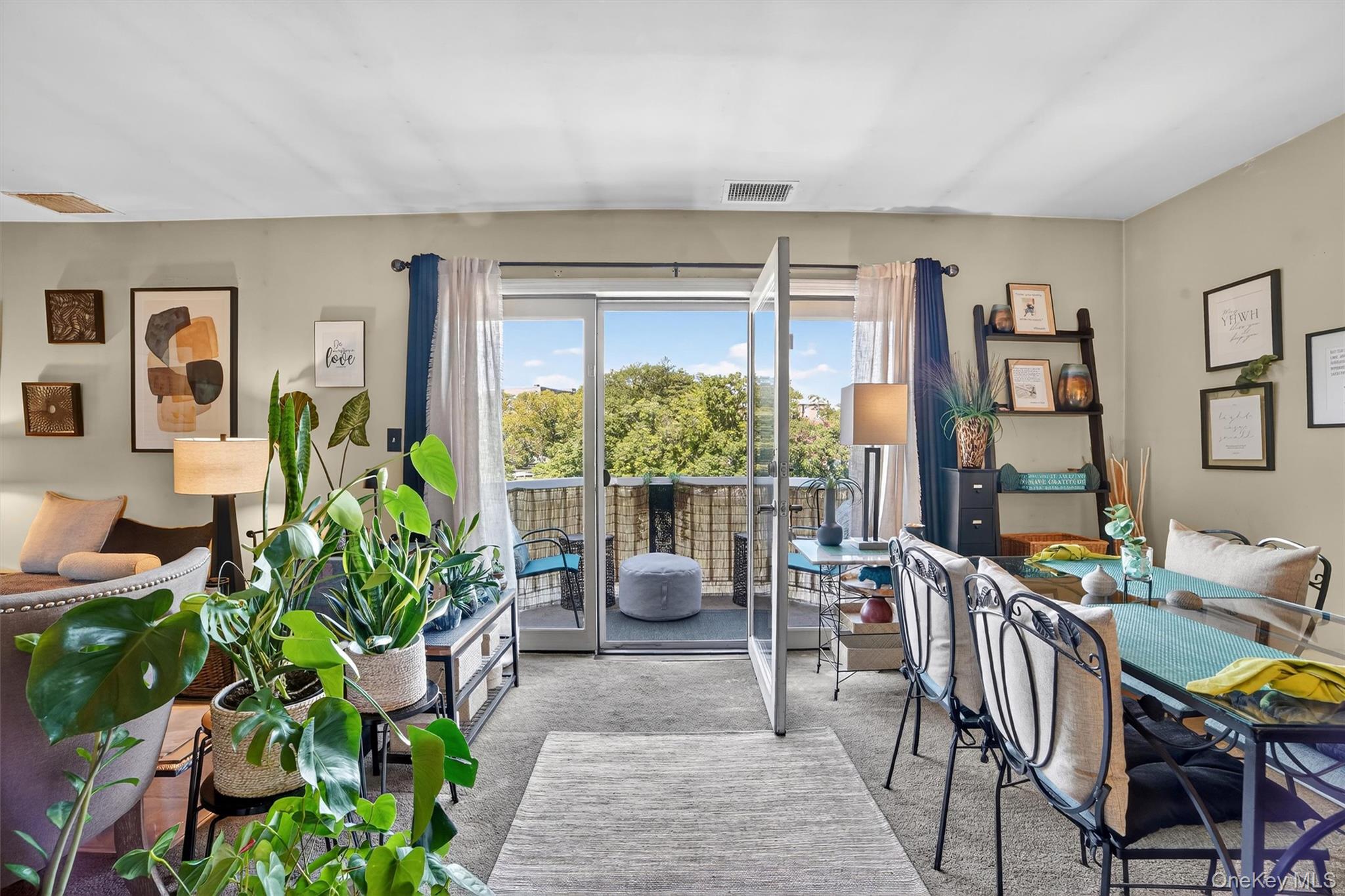 37 Harbor Lane, Unit 2A New Rochelle, NY 10805 - Photo 7 of 23 a living room with furniture potted plant floor to ceiling windows and a potted plant