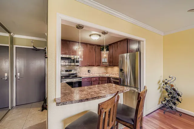 a kitchen with refrigerator and cabinets