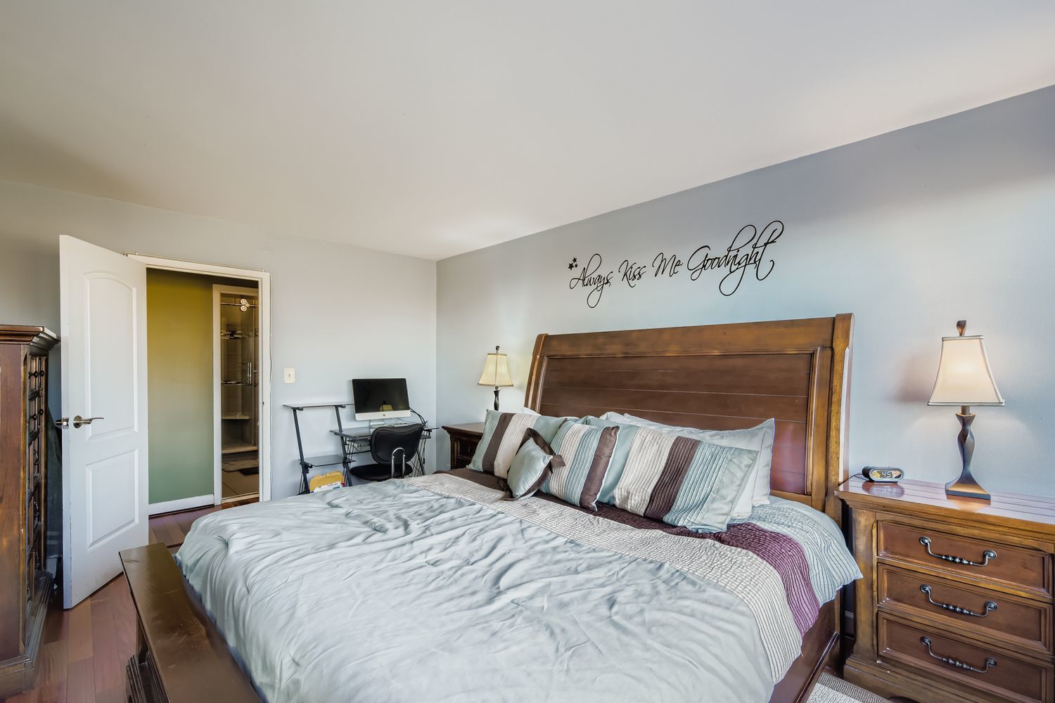 3930 North Pine Grove Avenue, Unit 805 Chicago, IL 60613 - Photo 8 of 15 a bed sitting in a bedroom with a lamp