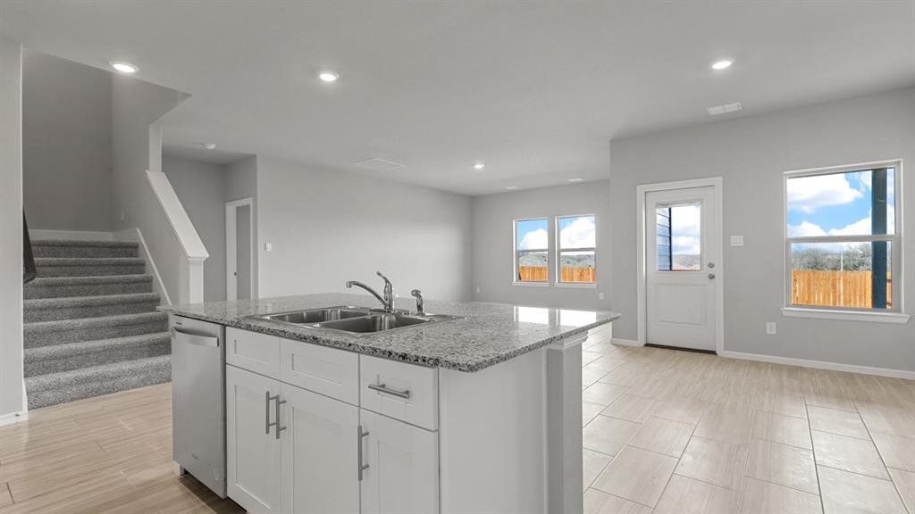 a kitchen with sink and window