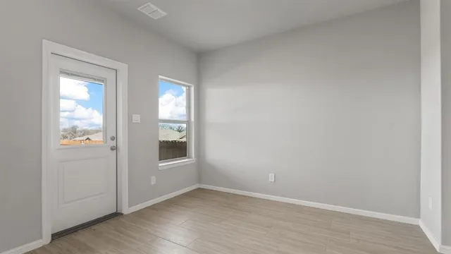 an empty room with windows and closet