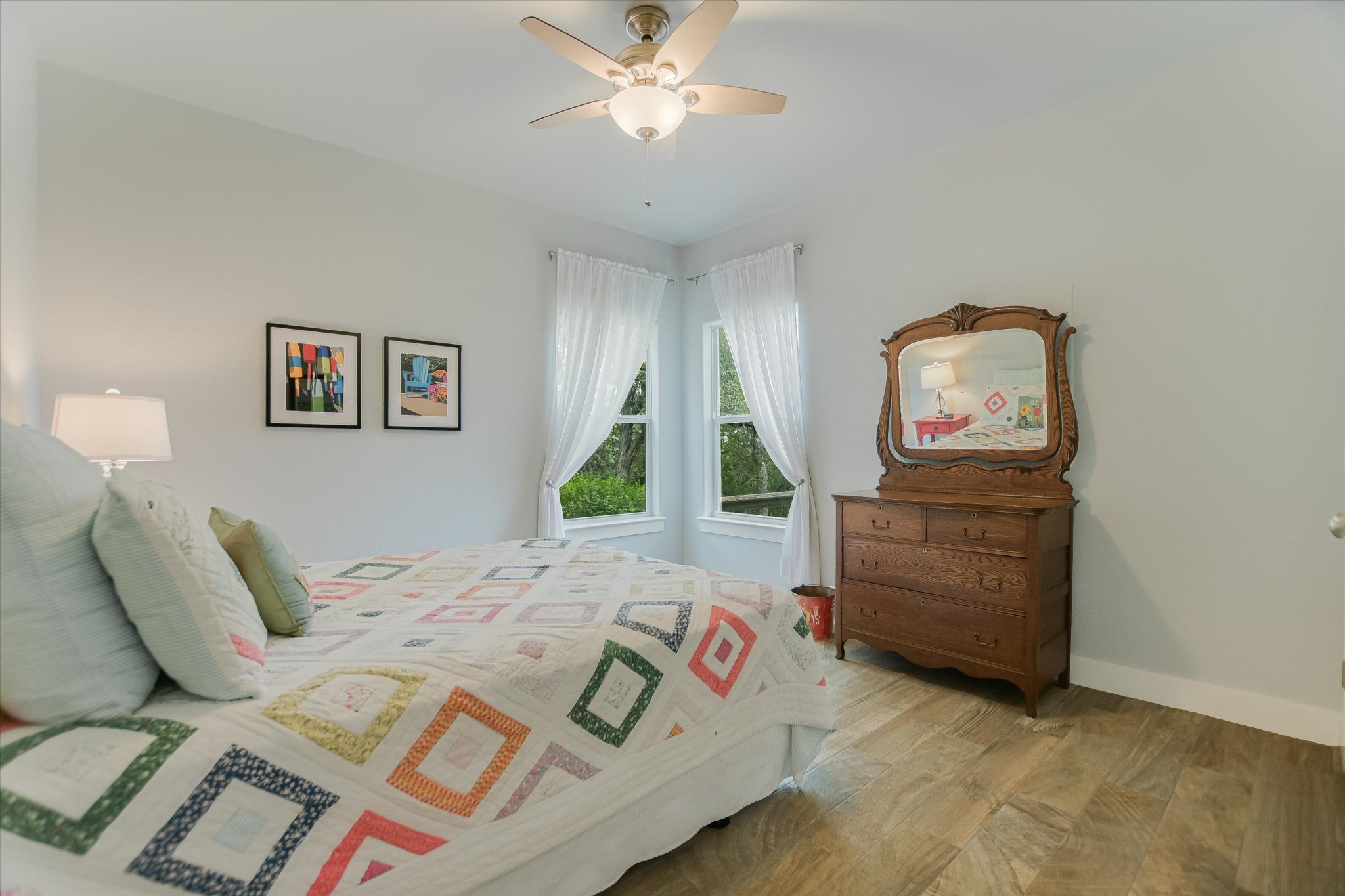 590 Rancho Grande Drive Wimberley, TX 78676 - Photo 20 of 30 a bedroom with a bed and a chandelier