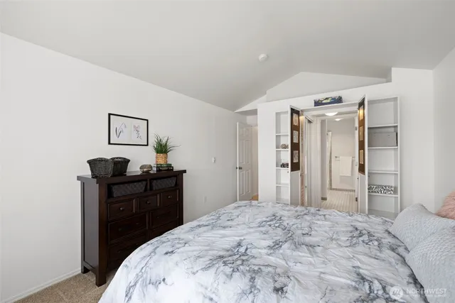 a bedroom with a bed and a dresser