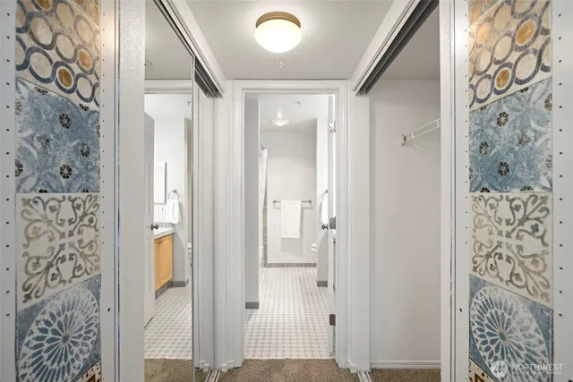 view of a bathroom with a shower and a door