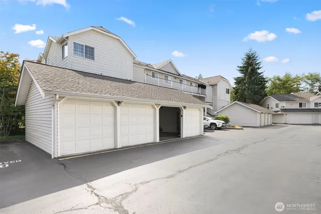 a view of house with entryway and garage