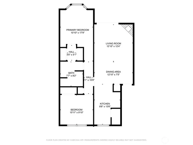 a picture of a bench in front of a wall