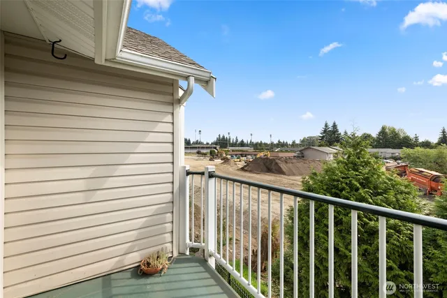a view of a balcony with wooden floor and fence