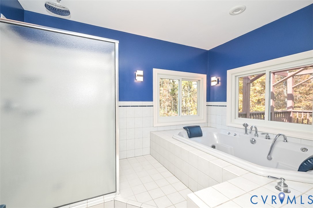 425 Starview Lane Gum Spring, VA 23065 - Photo 22 of 50 a bathroom with a tub sink and mirror