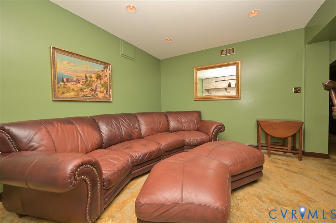 425 Starview Lane Gum Spring, VA 23065 - Photo 35 of 50 a blue couch sitting in a living room with a rug