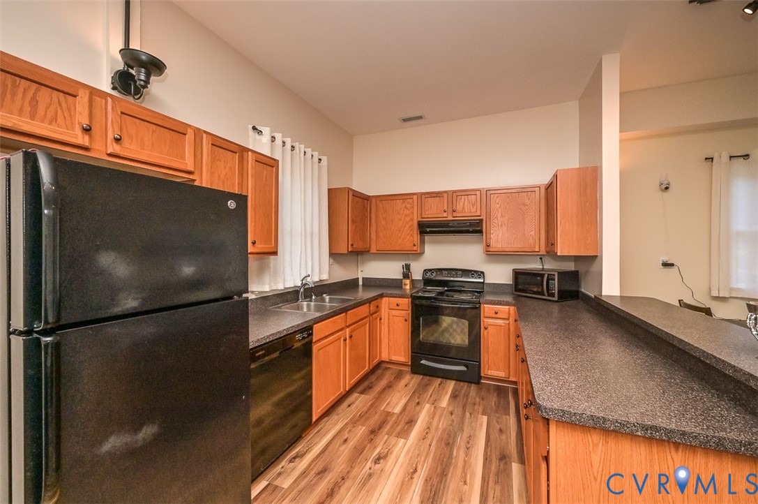 425 Starview Lane Gum Spring, VA 23065 - Photo 45 of 50 a kitchen with stainless steel appliances granite countertop a refrigerator a stove and a sink with wooden floor