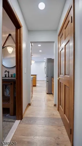 a kitchen with stainless steel appliances granite countertop a stove a sink and a refrigerator with wooden floor