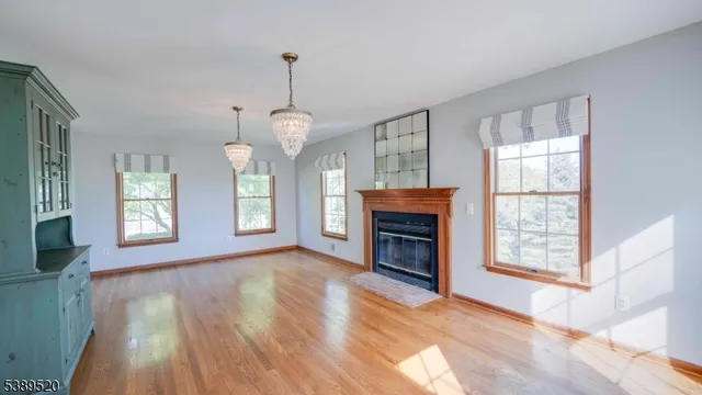 a living room with furniture a chandelier and a window