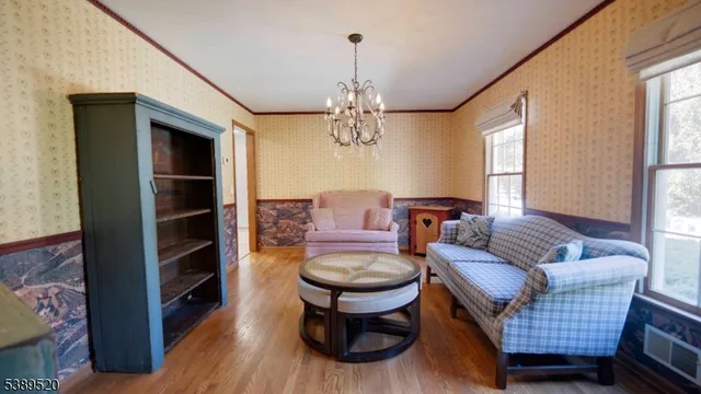 a living room with furniture a window and a chandelier