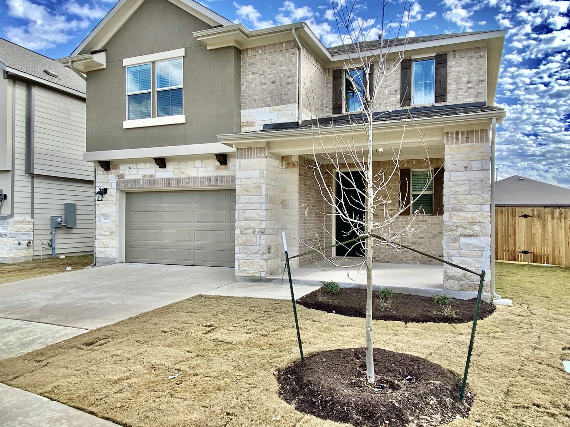 a front view of a house with garden