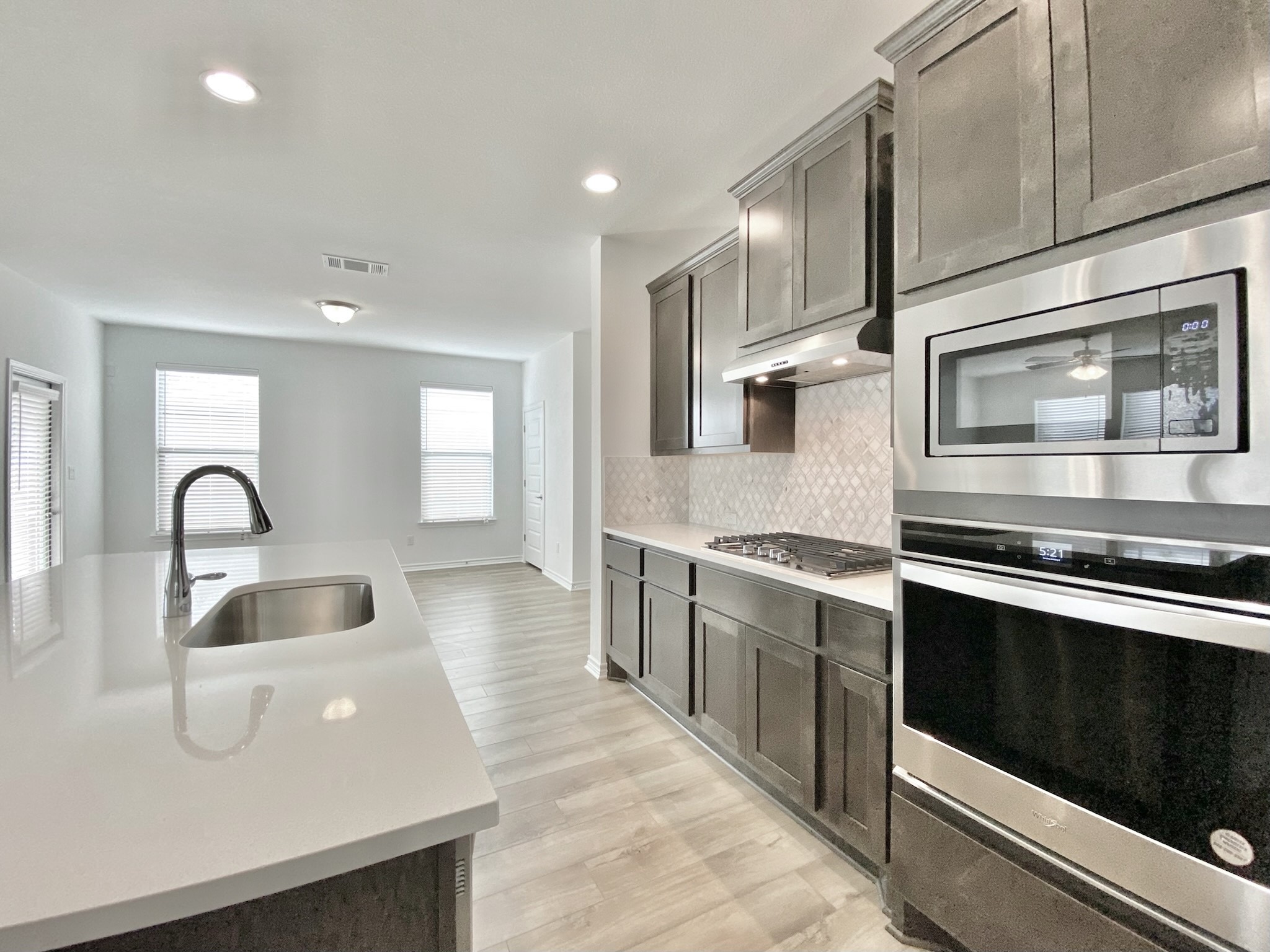 1852 Turtle Bay Loop Leander, TX 78641 - Photo 12 of 38 a kitchen with stainless steel appliances granite countertop a sink and stove top oven