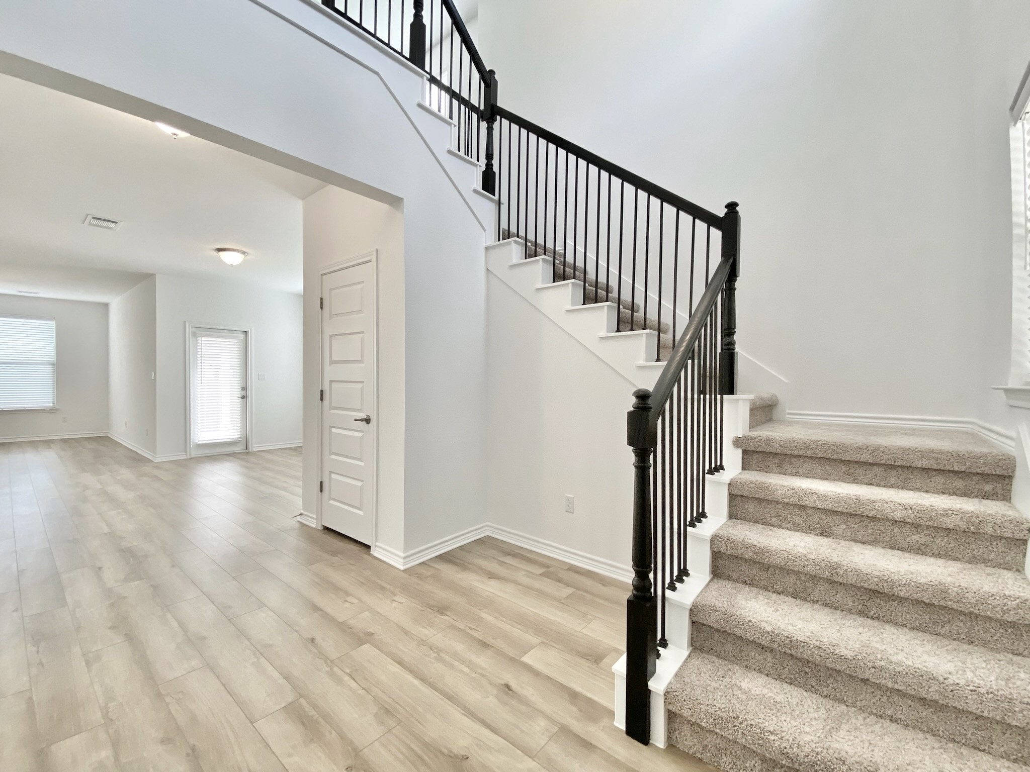 1852 Turtle Bay Loop Leander, TX 78641 - Photo 21 of 38 a view of staircase with white walls and railing