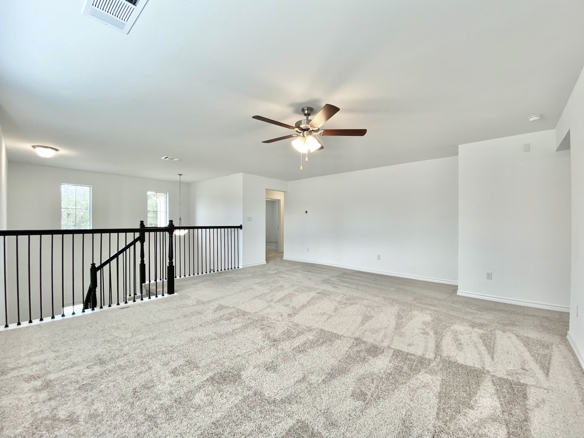 1852 Turtle Bay Loop Leander, TX 78641 - Photo 22 of 38 a view of a livingroom with a ceiling fan and wooden floor