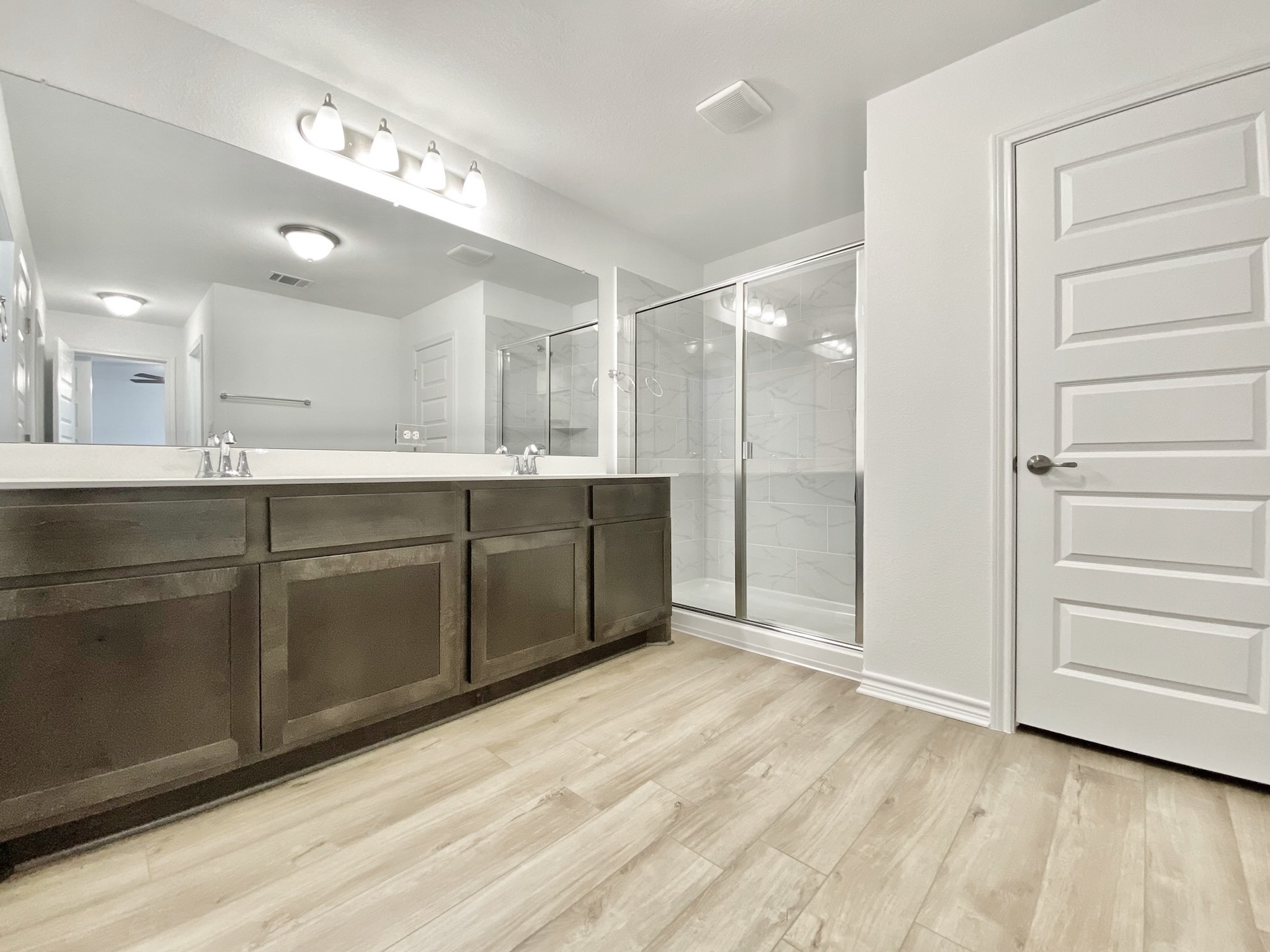 1852 Turtle Bay Loop Leander, TX 78641 - Photo 26 of 38 a spacious bathroom with a mirror a sink and shower