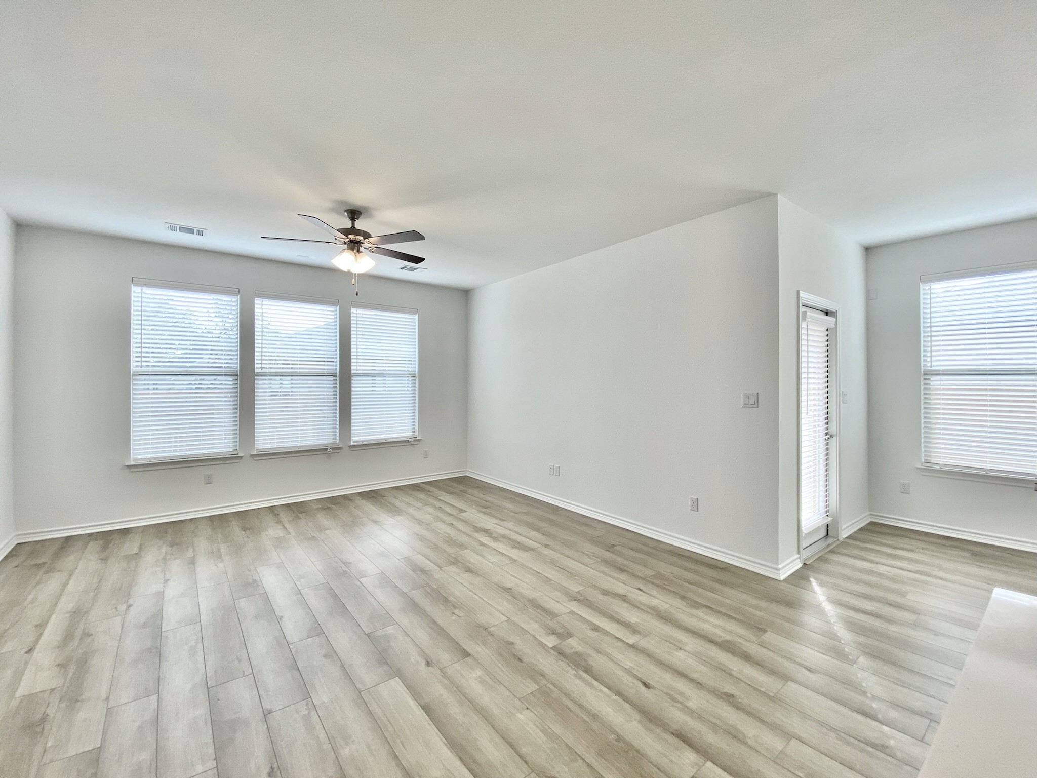 1852 Turtle Bay Loop Leander, TX 78641 - Photo 5 of 38 wooden floor in an empty room with a window