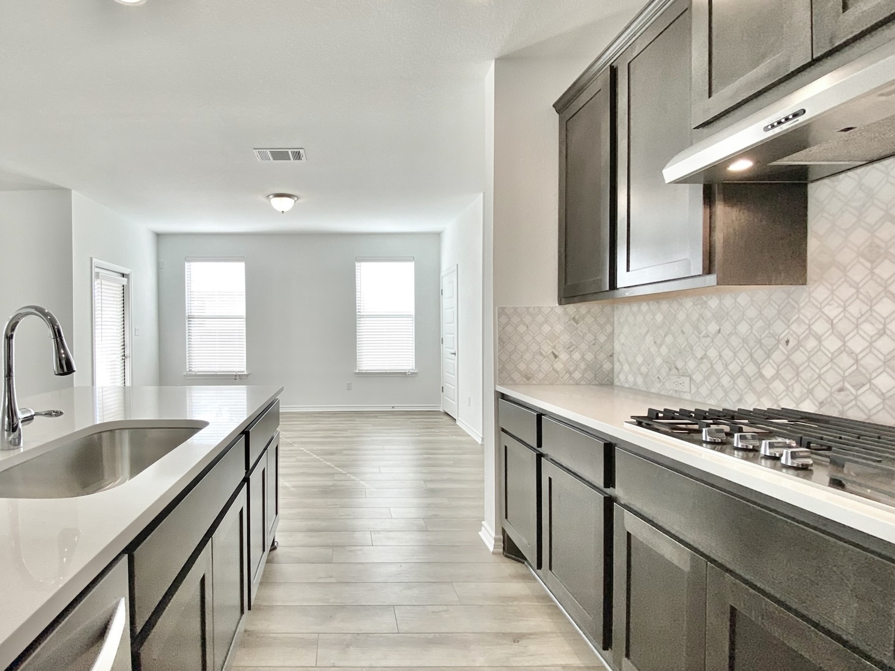 1852 Turtle Bay Loop Leander, TX 78641 - Photo 9 of 38 a kitchen with granite countertop a sink and cabinets
