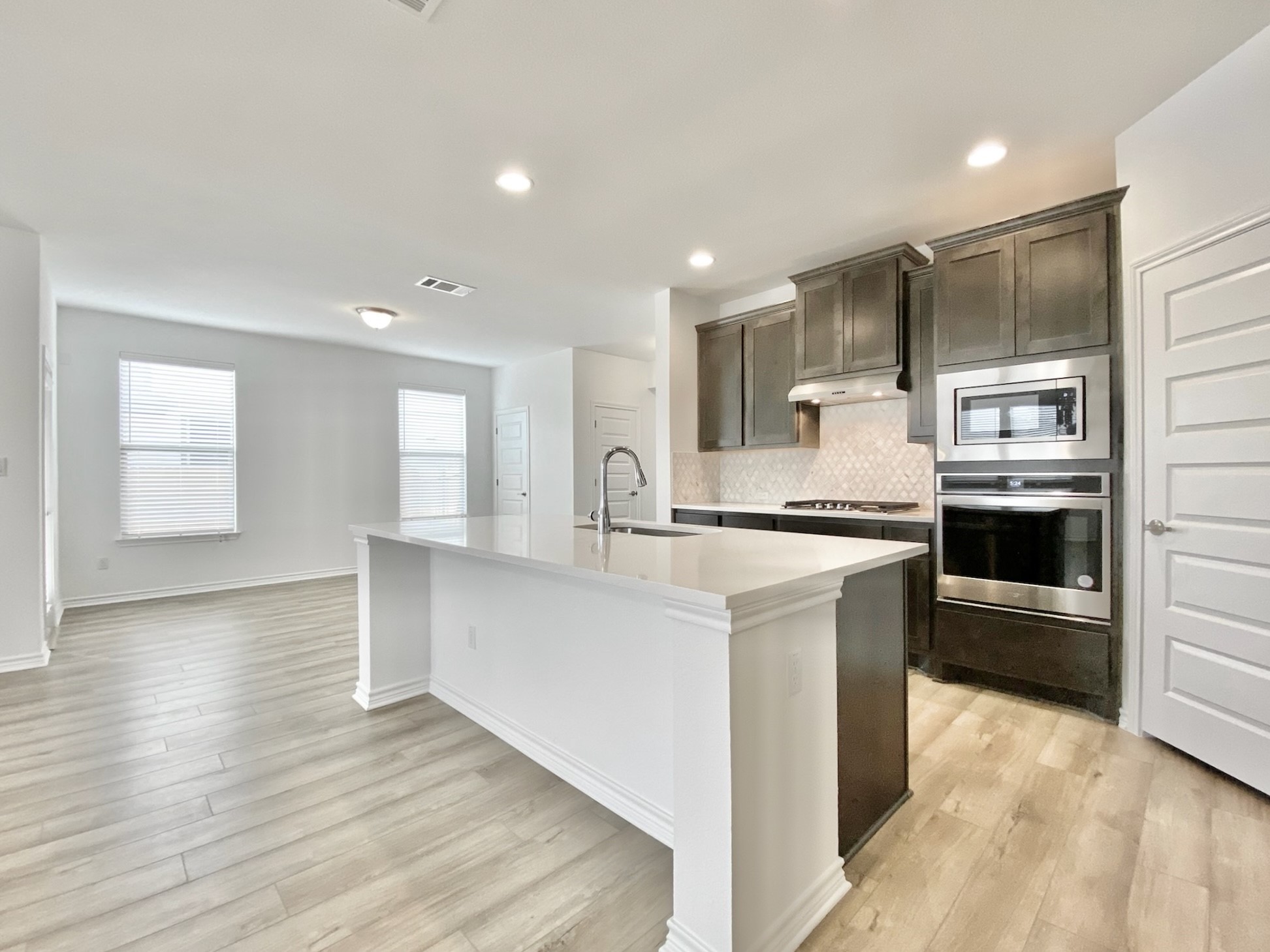 1852 Turtle Bay Loop Leander, TX 78641 - Photo 10 of 38 a large kitchen with kitchen island a sink stainless steel appliances and cabinets