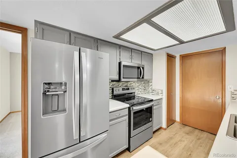 a kitchen with stainless steel appliances a refrigerator stove and sink
