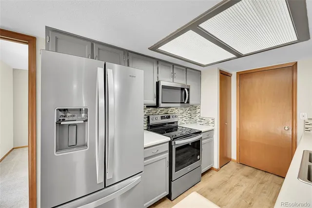 a kitchen with stainless steel appliances a refrigerator stove and sink