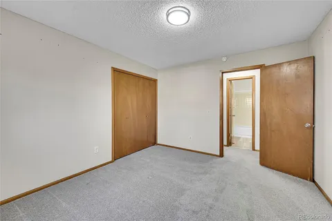 an empty room with closet area