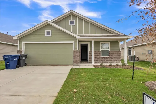 a front view of house with yard and green space