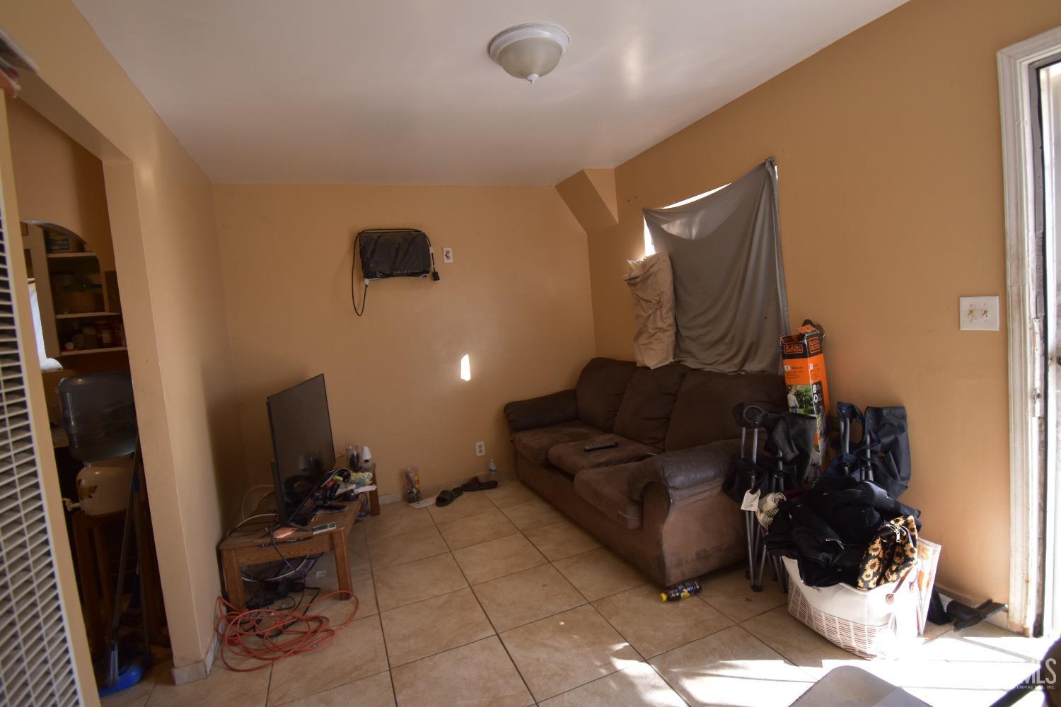 Undisclosed Address Bakersfield, CA 93305 - Photo 14 of 23 a living room with furniture and a flat screen tv