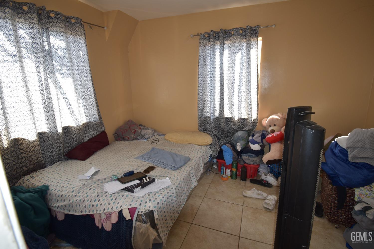 Undisclosed Address Bakersfield, CA 93305 - Photo 16 of 23 a living room with furniture and a window