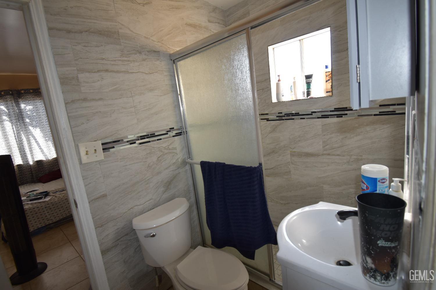 Undisclosed Address Bakersfield, CA 93305 - Photo 20 of 23 a bathroom with a toilet and a sink