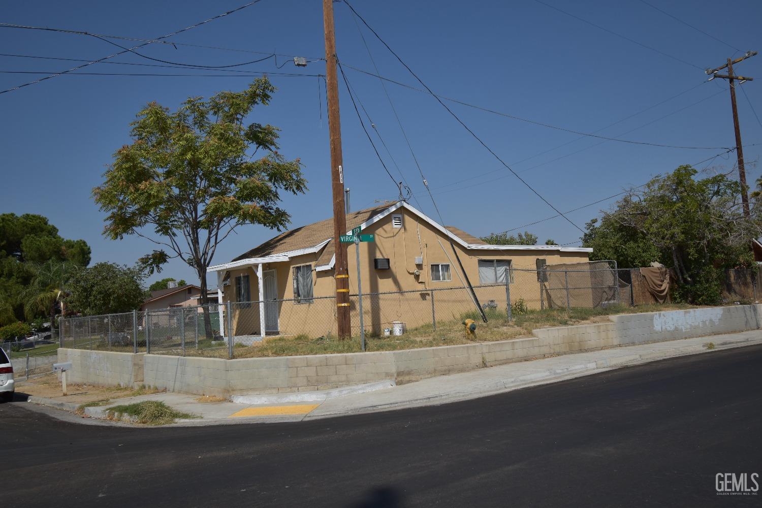 Undisclosed Address Bakersfield, CA 93305 - Photo 6 of 23 a front view of a house with a garden