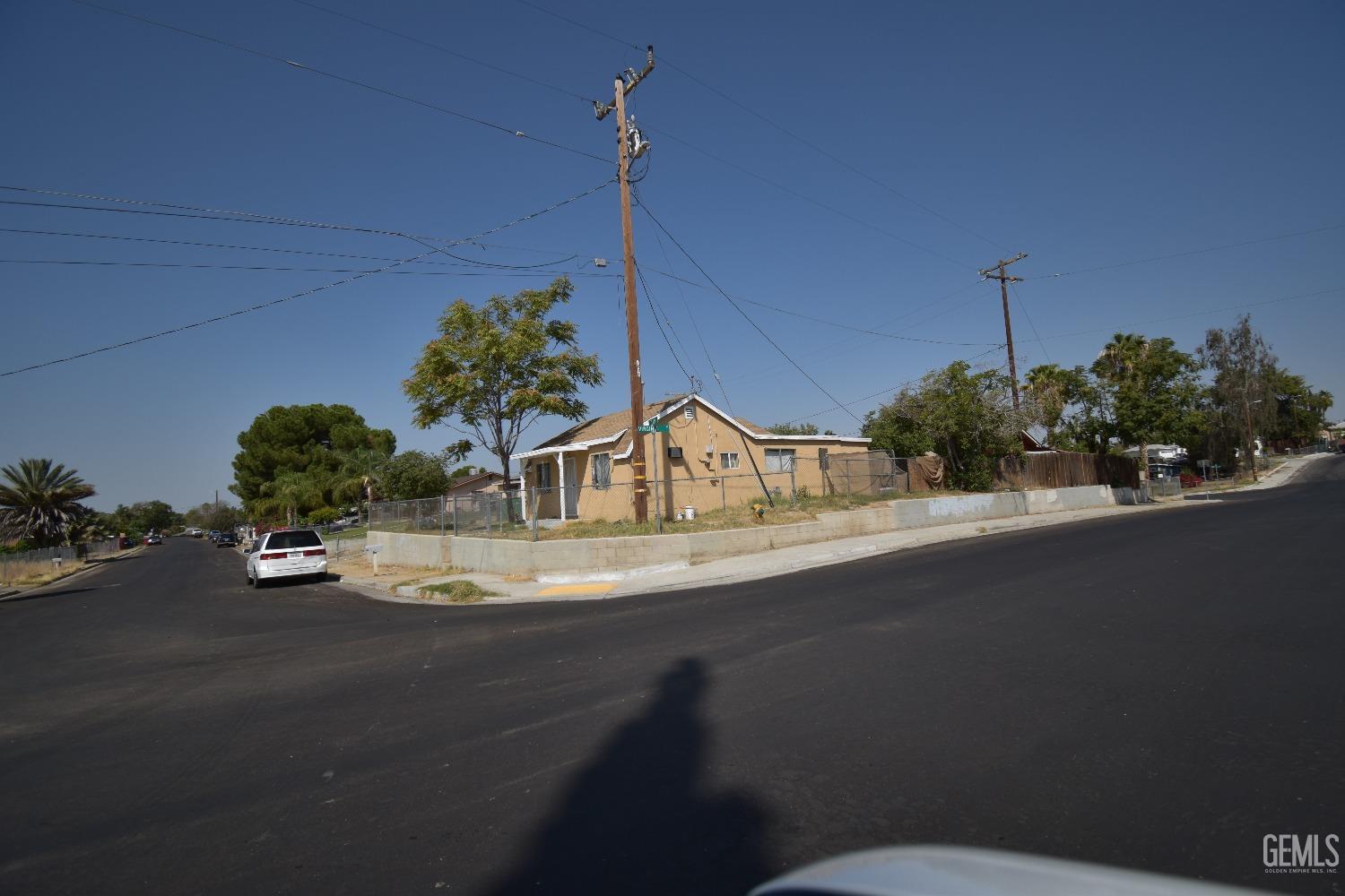 Undisclosed Address Bakersfield, CA 93305 - Photo 7 of 23 a front view of a house with a yard