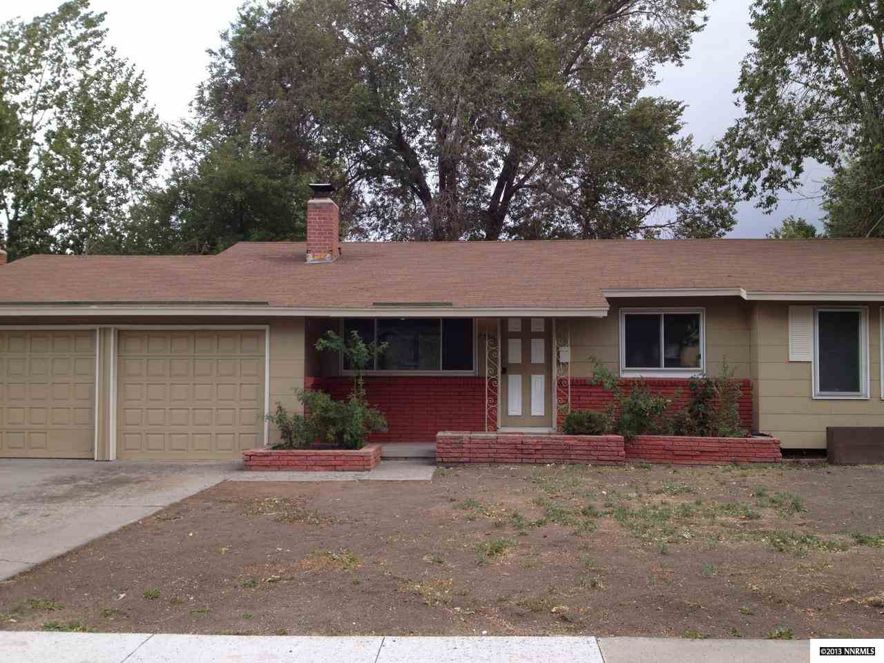 4530 Azalea Drive Reno, NV 89502 - Photo 1 of 1 a front view of a house with a yard and garage