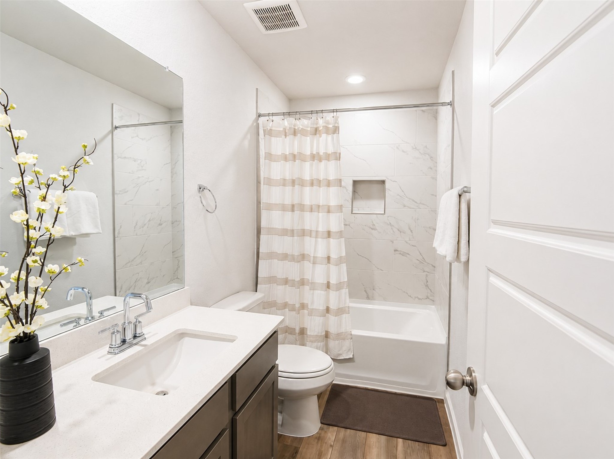 1924 Split Rock Road New Braunfels, TX 78130 - Photo 15 of 20 Marble-patterned wall tile and a sleek vanity highlight this clean, modern bathroom design.