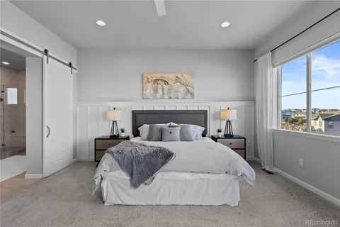 a bedroom with a large bed and a window