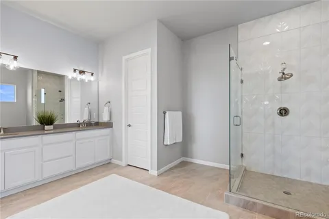 a spacious bathroom with a shower and a sink