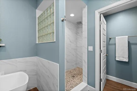 a bathroom with a bathtub and shower