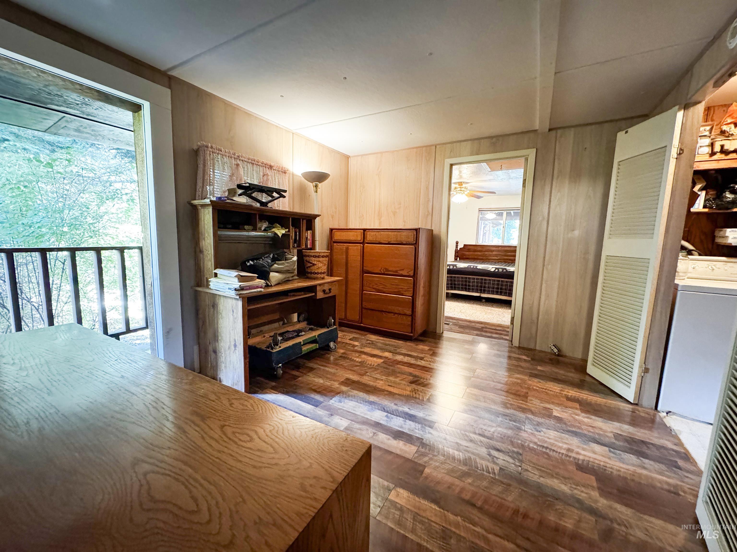 4482 Council Cuprum Road Council, ID 83612 - Photo 14 of 45 Office with dark wood finished floors, wood walls, washer / clothes dryer, and a ceiling fan