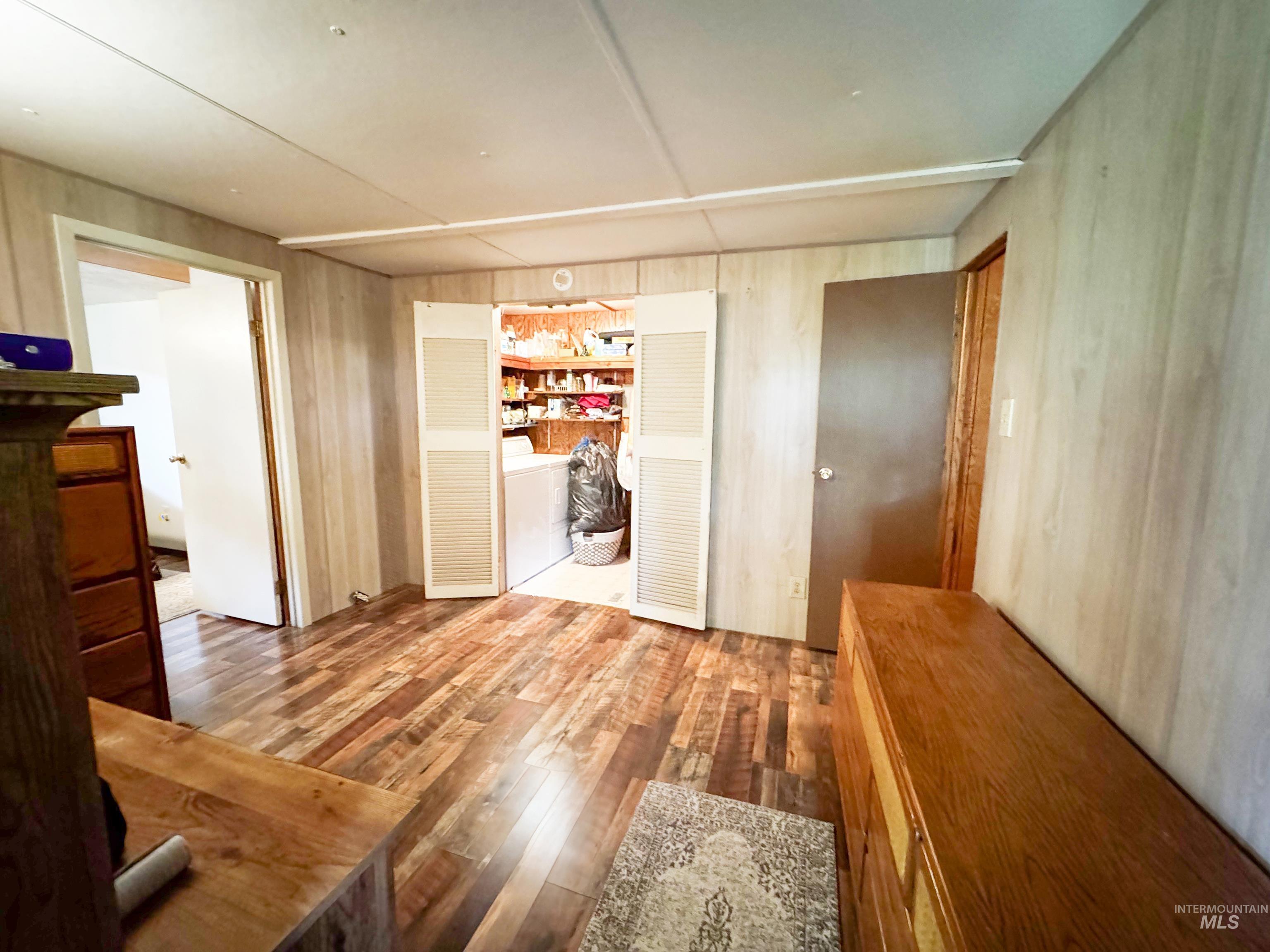 4482 Council Cuprum Road Council, ID 83612 - Photo 15 of 45 Corridor featuring wood finished floors and washer / clothes dryer