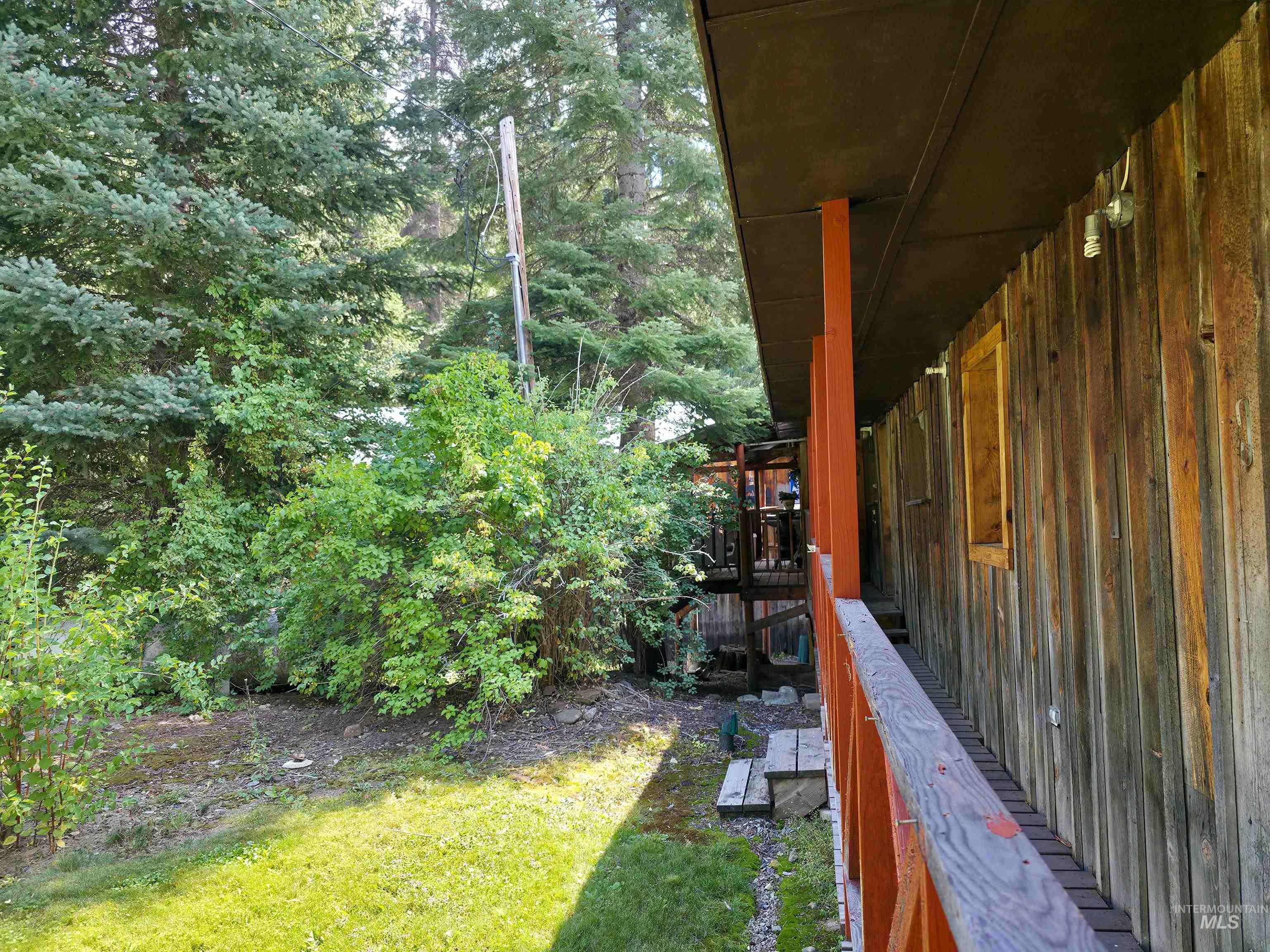 4482 Council Cuprum Road Council, ID 83612 - Photo 19 of 45 View of green lawn featuring a deck and a view of trees