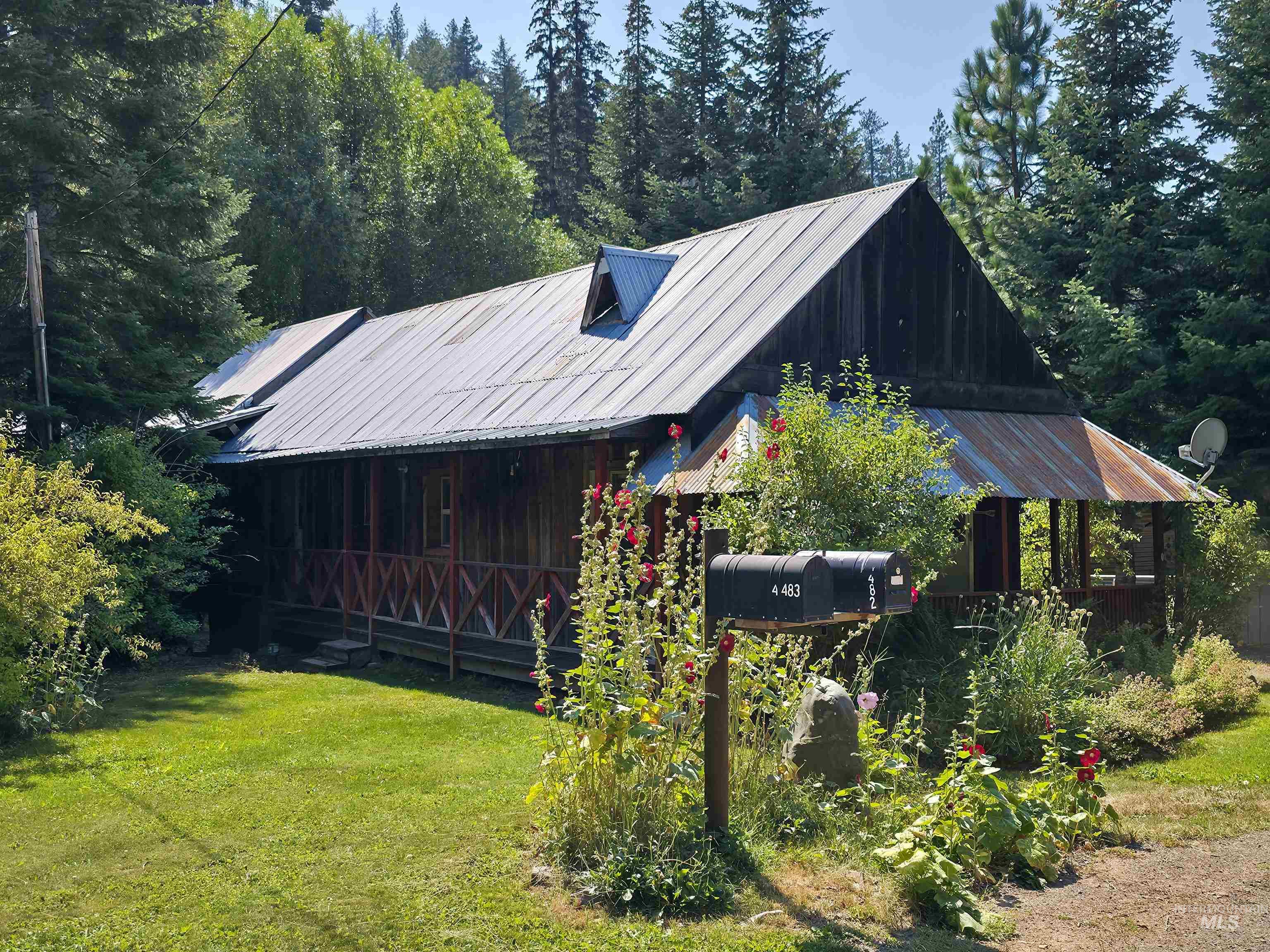 4482 Council Cuprum Road Council, ID 83612 - Photo 2 of 45 View of front of property with a metal roof and a front lawn