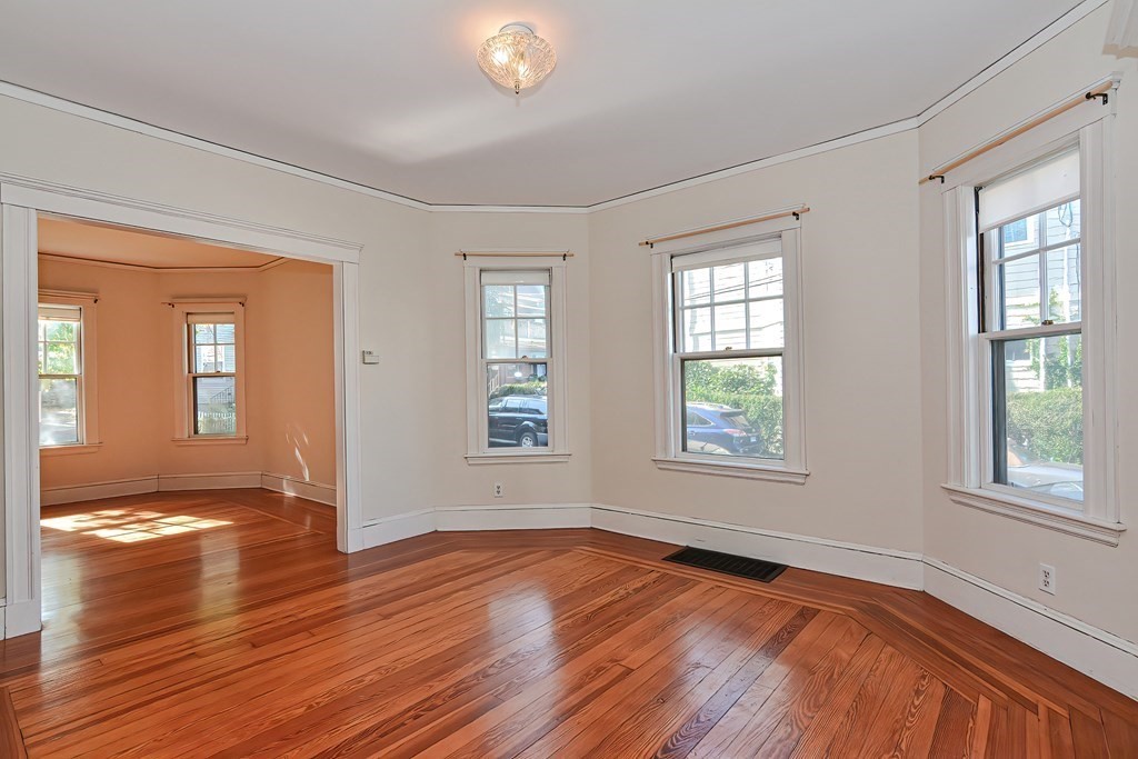 17-19 Walnut Road Somerville, MA 02145 - Photo 12 of 42 a view of an empty room with wooden floor and a window