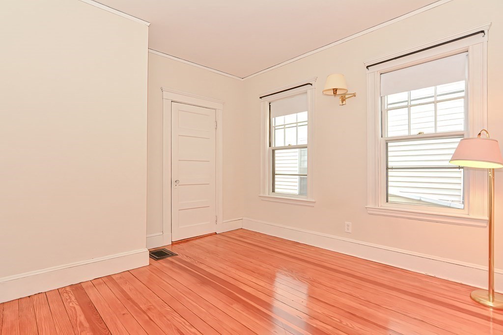 17-19 Walnut Road Somerville, MA 02145 - Photo 15 of 42 an empty room with wooden floor and windows