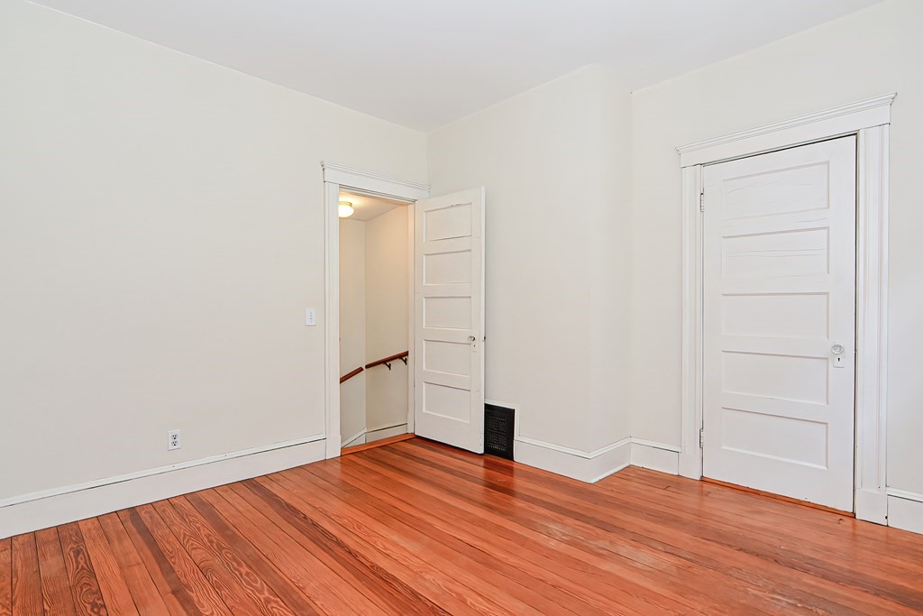 17-19 Walnut Road Somerville, MA 02145 - Photo 17 of 42 a view of empty room with wooden floor